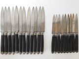 several knives are lined up next to each other on a white surface