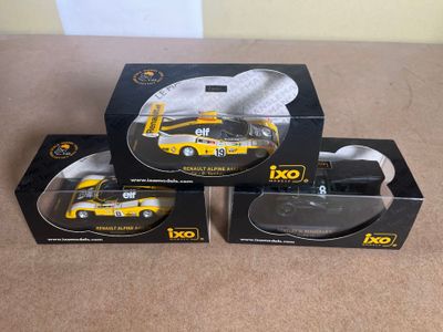 three boxed boxes of toy cars sitting on top of a table