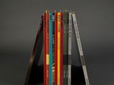 books stacked on top of each other on a black surface