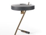 a black and gold table with a metal base and a black top