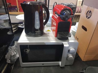 a microwave and a kettle sitting on top of it