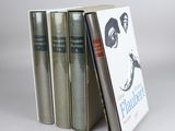 three books are stacked on top of each other on a table