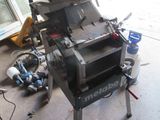 a machine that is sitting on the ground in the garage