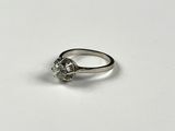a close up of a diamond ring on a white surface