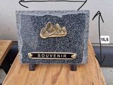 a stone plaque with a mountain on it sitting on a table
