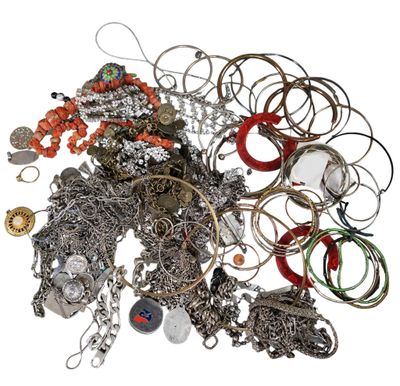 a pile of assorted jewelry on a white surface