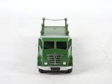 a green toy truck that is sitting on a white surface