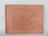 an old book with a brown cover sitting on top of a table