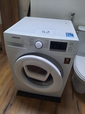 a washer and a toilet in a small room