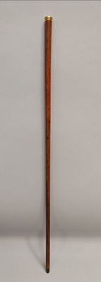 a wooden stick that is leaning against a wall