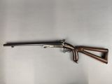 an old gun with a wooden handle and a metal handle