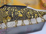 yellow, black, and grey scarf with a picture of a bird on it