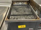 a grill that is sitting in the middle of a kitchen