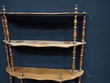 a wooden shelf that has three shelves on it