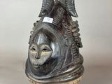 an image of a sculpture of a head on a wooden stand
