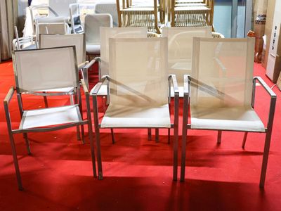 four chairs in a room with a red carpet
