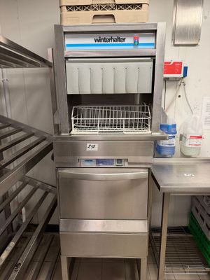 a stainless steel dishwasher in a commercial kitchen
