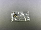 a plastic bag filled with small figures sitting on top of a table