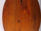 an old wooden clock is sitting on a white surface