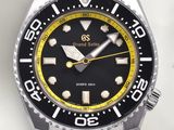 a black and yellow watch with a yellow second hand