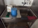 a sink with a blue bucket and a blue bucket on it