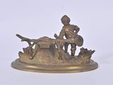 a bronze figurine of a man with a gun on a table