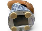 a blue and white porcelain shoe with a tag on it