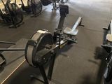 an image of a gym room with a row of exercise bikes