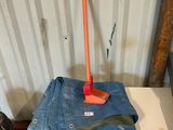 a table with a pair of jeans on it and an orange handle