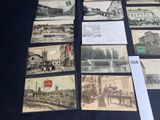 many pictures of old buildings on display on the table
