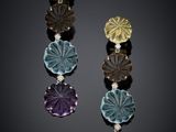 a close up of a pair of earrings on a black surface