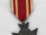 an old medal with a star on it sitting on top of a table