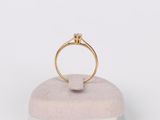a close up of a gold ring with a diamond on top of it