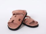 a close up of a pair of pink sandals on a white background
