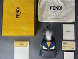 a small bag with a keychain and other items on a table