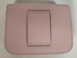 a pink purse with a small card holder on top of it