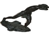 statue of a man on a surfboard on top of a rock