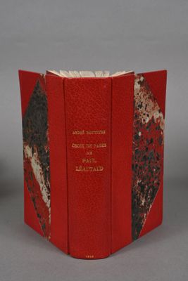 an open book with a red cover and a black and white design
