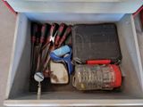 a box with tools in it sitting on the floor