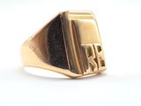 an image of a gold signet ring with a black stone