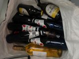 many bottles of wine in a bag on the table