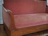 a couch that is sitting in a room with a rug on the floor