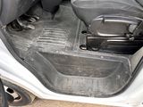 the interior of a car with the door open and the seat down