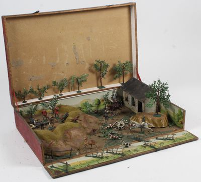 une valise ouverte contenant une maquette de maison