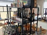 many bottles of alcohol on the counter in the store