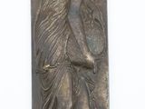 an image of a metal plaque with a woman on it