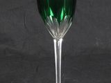 a green wine glass sitting on a black table