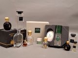many different bottles of perfume on the table