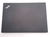 a laptop that is sitting on a white surface
