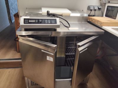 a stainless steel oven with a door open on a kitchen counter